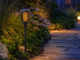 3in1 Solar Flame Torch Light mounted on exterior wall at dusk