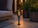 3in1 Solar Flame Torch Light as garden path stake light surrounded by plants