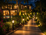 Solar garden path lights lining a tropical garden walkway at night