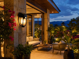 Solar wall lantern mounted on stone pillar of luxury patio at dusk